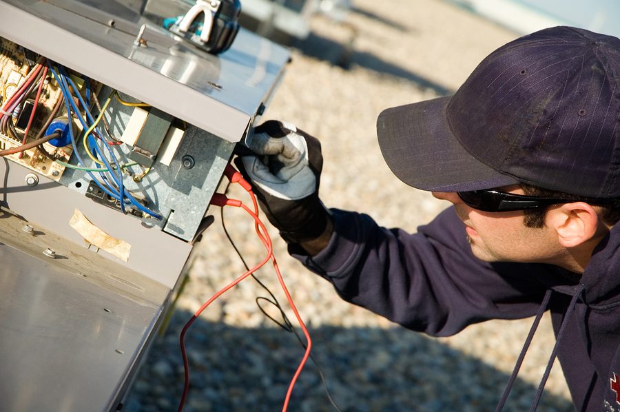 HVAC technician doing maintenance.